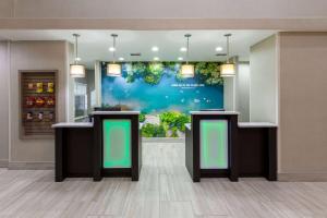 a lobby with green signs on the wall at La Quinta by Wyndham New Braunfels in New Braunfels