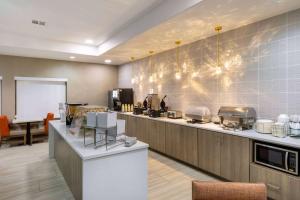 a large kitchen with a counter with many appliances at La Quinta by Wyndham New Braunfels in New Braunfels