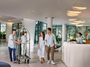 a group of people standing in a lobby at Premier Residences Phu Quoc Emerald Bay Managed by Accor in Phu Quoc