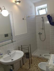 a bathroom with a sink and a shower and a tub at B&B Il Secolo Breve in Ortona