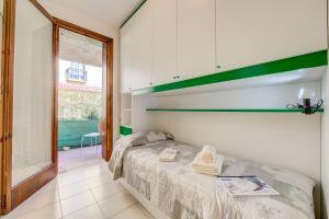 a bedroom with a bed in a room with a window at Cinzia Apartment Front Beach - Happy Rentals in Sirmione