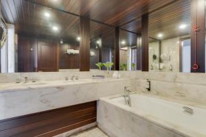 a bathroom with three sinks and a large mirror at Pestana Bahia Praia Nature & Beach Resort in Vila Franca do Campo