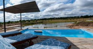 a swimming pool with a view of a river at Casa de la Presa 3 in Polokwane