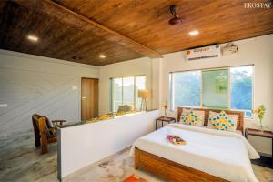a bedroom with a bed and a large window at EKOSTAY - Casa Royale Villa in Alibaug