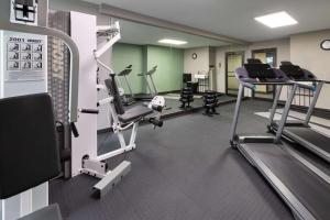 a gym with several treadmills and elliptical machines at Wingate by Wyndham Troy in Troy