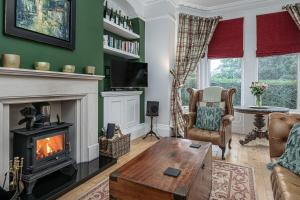 a living room with a fireplace and a couch at No22, Llandudno - Stylish & Cosy Period Apartment, with Hot Tub & Private Parking in Llandudno