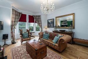 a living room with a couch and a table at No22, Llandudno - Stylish & Cosy Period Apartment, with Hot Tub & Private Parking in Llandudno