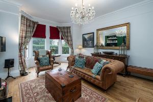 a living room with a couch and a table at No 22 with Hot Tub & Parking in Llandudno