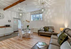 a living room with a couch and a table at Honey Hirst in Shotley Bridge