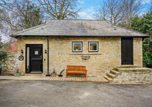 a brick house with a bench in front of it at Honey Hirst in Shotley Bridge