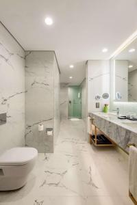 a white bathroom with a toilet and a sink at Hyatt Regency Nairobi Westlands in Nairobi