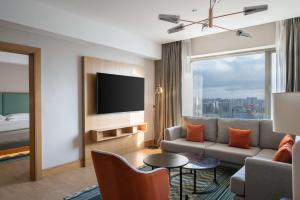 a living room with a couch and a tv at Hyatt Regency Nairobi Westlands in Nairobi