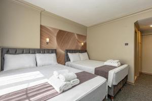 Postel nebo postele na pokoji v ubytování BURSA LOYAL CiTY HOTEL