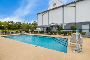 a swimming pool in front of a building at Spark By Hilton Tifton in Tifton