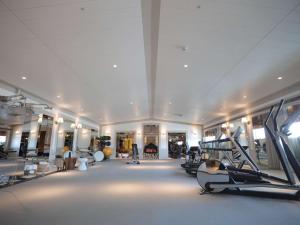 a gym with treadmills and machines in a room at Dunhua Mansion Taipei - MGallery Collection in Taipei