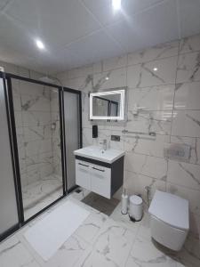 a bathroom with a toilet and a sink and a shower at Olive Hotel in Pamukkale