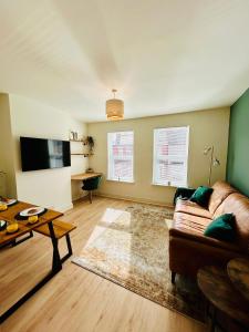 a living room with a couch and a table at Kensington Park in Reading