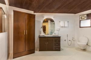 a bathroom with a toilet and a sink and a mirror at Maple Resort Chail in Chail +66 photos