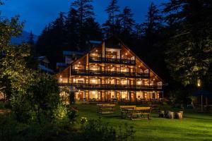 a large wooden building with lights on it at night at Bedzzz Xclusiv Baikunth, Manali By Leisure Hotels - 650 meters from Hidimba Devi Temple in Manāli