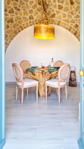a dining room with a wooden table and chairs at Lady Stamatias House in Halki