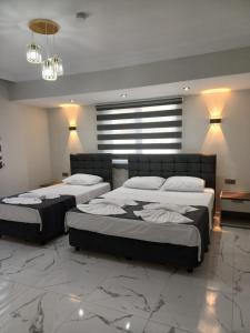 a bedroom with two beds and a chandelier at Olive Hotel in Pamukkale