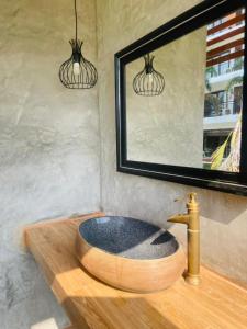 a bathroom with a wooden sink and a mirror at Remember Vangvieng Hotel in Vang Vieng
