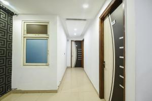 a corridor with a door and a window in a building at FabHotel The Royal Residency in New Delhi