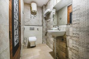 a bathroom with a sink and a toilet at FabHotel The Royal Residency in New Delhi