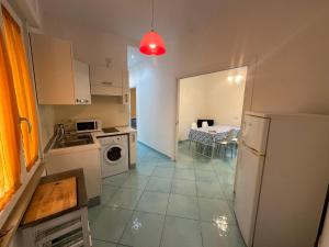 a small kitchen with a white refrigerator and a table at Il Sirenio in Sorrento