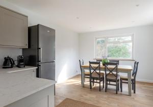a kitchen and dining room with a table and chairs at Cherry Trees - Acton in Waldingfield
