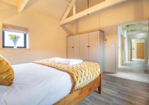 a bedroom with a large bed in a room at White House Lodges - Tawny in Heveningham