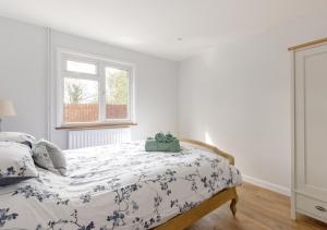 a bedroom with a bed and a window at Cherry Trees - Acton in Great Waldingfield