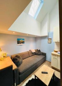 a living room with a couch and a window at Münsterland Cottage in Lengerich