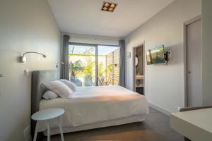 a bedroom with a large bed and a table at Lafitenia Resort in Saint-Jean-de-Luz