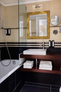 a bathroom with a sink and a mirror at Hotel St.Gotthard in Zürich