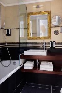 a bathroom with a sink and a mirror at Hotel St.Gotthard in Zurich