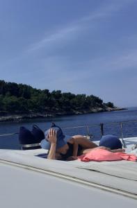 a woman laying on a bed on a boat at Felicita in Marina di Portisco