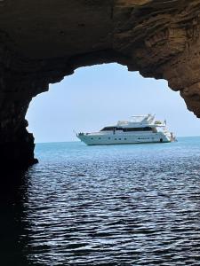a cruise ship in the ocean through a cave at Felicita in Marina di Portisco