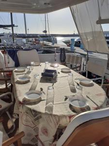 a table on a boat with plates and glasses on it at Felicita in Marina di Portisco