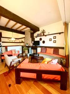 a bedroom with two beds and a living room at Mountain apartment with marvelous view near slopes in Barzio