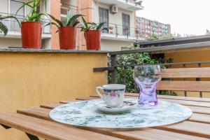 einen Tisch mit einer Tasse und einem Glas darauf in der Unterkunft VILLA POLLICINO - outdoor patio, 10-minute walk to metro in Mailand