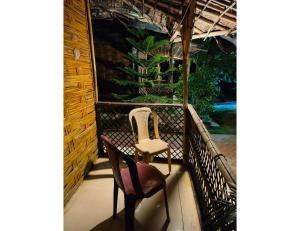 two chairs and a chair on a balcony at Shreeji Farm and Resort, Jalondar, Gujarat in Chāndawāri