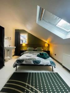 a bedroom with a large bed and a window at Seaside Victorian Gate lodge in Warrenpoint