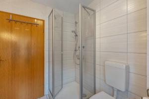 a bathroom with a shower with a toilet and a glass door at Ferienhaus Bodebaude in Thale +21 photos