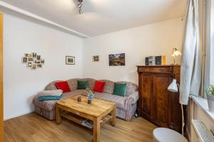a living room with a couch and a table at Ferienhaus Bodebaude in Thale