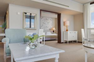a living room with a vase of flowers on a table at Pestana Bahia Praia Nature & Beach Resort in Vila Franca do Campo