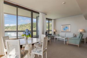 a living room with a table and chairs at Pestana Bahia Praia Nature & Beach Resort in Vila Franca do Campo