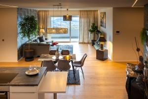 a living room with a couch and a table at Apartment Skyline Graz Villa Stattegg in Stattegg