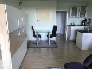 a dining room with a table and two chairs at Sunnyside 95 in Timmendorfer Strand +23 photos