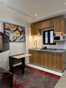 a kitchen with a table and a counter top at Klik Klak Appart Hotel in Cotonou